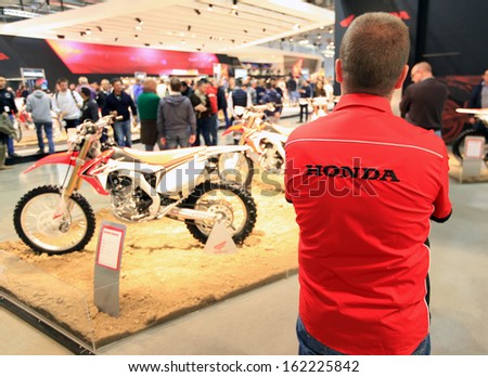 MILAN, ITALY - NOVEMBER 7: Honda staff member at motorcycle products exhibition area during EICMA, 71st International Motorcycle Exhibition on November 7, 2013 in Milan, Italy.
