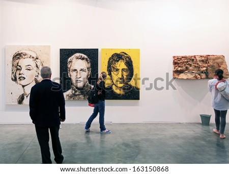 MILAN, ITALY - APRIL 08: People look at paintings galleries during MiArt, international exhibition of modern and contemporary art on April 08, 2011 in Milan, Italy