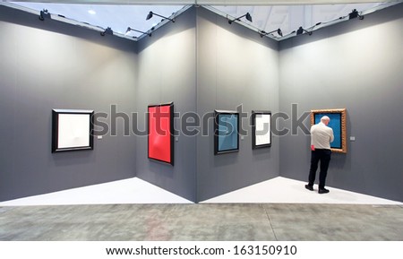 MILAN, ITALY - APRIL 08: A man looking at paintings galleries during MiArt, international exhibition of modern and contemporary art on April 08, 2011 in Milan, Italy