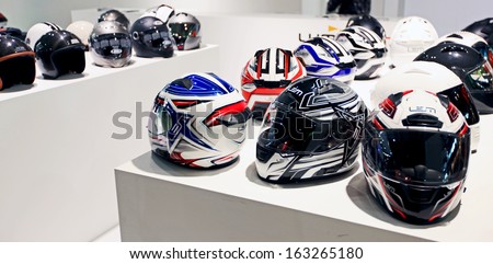 MILAN, ITALY - NOVEMBER 7: Brand new motorcycles helmets exhibition area during EICMA, 71st International Motorcycle Exhibition on November 7, 2013 in Milan, Italy.