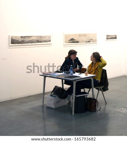 MILAN - APRIL 07: Women talking at paintings gallery at MiArt, international exhibition of modern and contemporary art April 07, 2013 in Milan, Italy.
