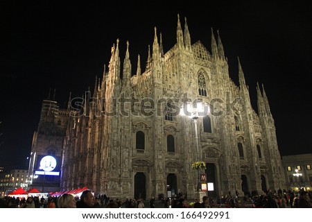 MILAN, ITALY - DECEMBER 5: People arrive at Duomo Cathedral Square to participate at Christmas Tree lights inauguration December 5, 2013 in Milan, Italy.