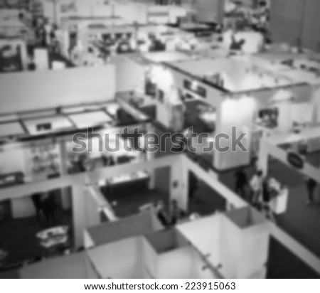 Trade show panoramic view, intentionally blurred post production. Black and white.