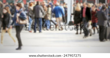 People crowd, commuters. Intentionally blurred background.