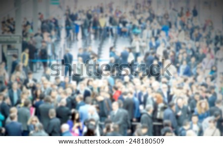 People crowd. Intentionally blurred background.