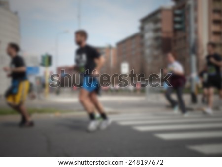 Runners racing on the street. Intentionally blurred post production.