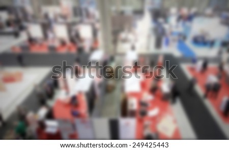 Panoramic view of a trade show. Intentionally blurred post production, humans and location not recognizable.