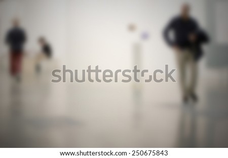 People visit art gallery. Intentionally blurred editing post production.