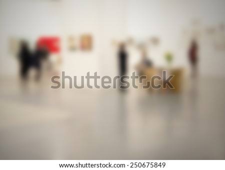 Art gallery with people, generic background. Intentionally blurred editing post production.
