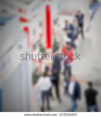 Trade show generic background. Intentionally blurred editing post production. People, works and location not recognizable.