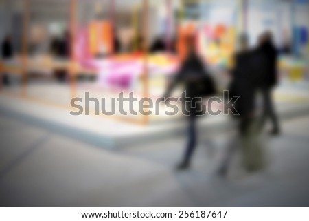 Trade show people. Intentionally blurred editing post production. Humans, location and products not recognizable.