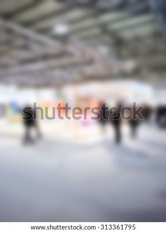 People at event, intentionally blurred post production background.