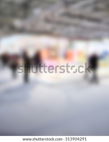 People during an event, intentionally blurred post production background.