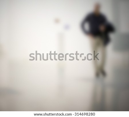 A man visits an art gallery, generic background, intentionally blurred post production.
