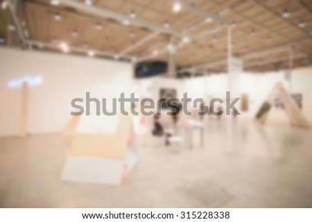 People visit art exhibition gallery generic background, intentionally blurred post production.