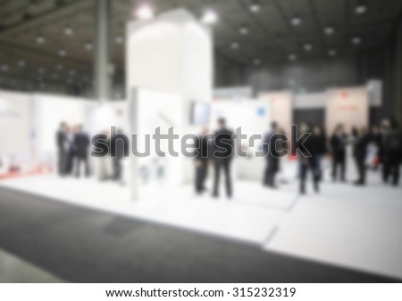 People, generic event background, intentionally blurred post production.