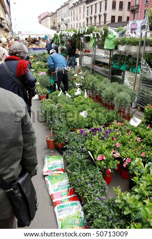 MILAN, ITALY - APRIL 11: People look for flowers on the street at the annual Flowers Market in the fashion and culture Navigli area April 11, 2010 in Milan, Italy.