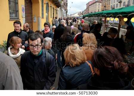 MILAN, ITALY - APRIL 11: Crowd on the street at the annual Flowers Market in the fashion and culture Navigli area April 11, 2010 in Milan, Italy.
