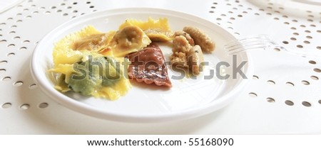 MANTOVA, ITALY - JUNE 14: Tasting pumpking and cherry hand made tortelli at Golosaria, national fair of food and gastronomy culture June 14, 2010 in Mantova, Italy.