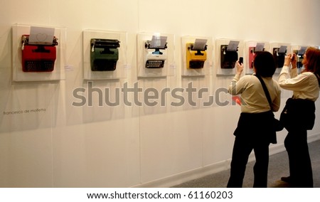 MILAN - MARCH 27: People look at works of modern art during MiArt ArtNow, international exhibition of modern and contemporary art March 27, 2010 in Milan, Italy.
