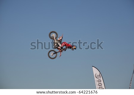 MILAN, ITALY - NOV. 11: Profile of motorcycle driver during acrobatic performance during Motolive show at EICMA, 67th International Motorcycle Exhibition November 11, 2009 in Milan, Italy.