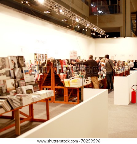 MILAN - MARCH 27: People look for books related to work of arts at MiArt ArtNow, international exhibition of modern and contemporary art March 27, 2010 in Milan, Italy.