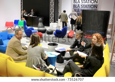 MILAN - APRIL 15: Looking at home interior design and decoration stands during the Salone del Mobile, annual international furnishing accessories exhibition on April 15, 2010 in Milan, Italy.