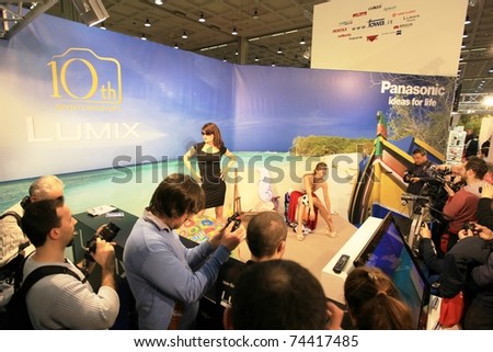 MILAN, ITALY - MARCH 26: People at Lumix stand take pictures of models during PHOTOSHOW, International Photo and Digital Imaging Exhibition on March 26, 2011 in Milan, Italy.