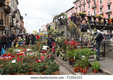 MILAN, ITALY - APRIL 11: People look for flowers and garden products at the annual Flowers Market in the fashion and culture Navigli area April 11, 2010 in Milan, Italy.