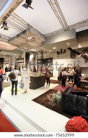 MILAN - APRIL 13: People look at interiors design stands and home architecture solutions at Salone del Mobile, international furnishing accessories exhibition on April 13, 2011 in Milan, Italy.