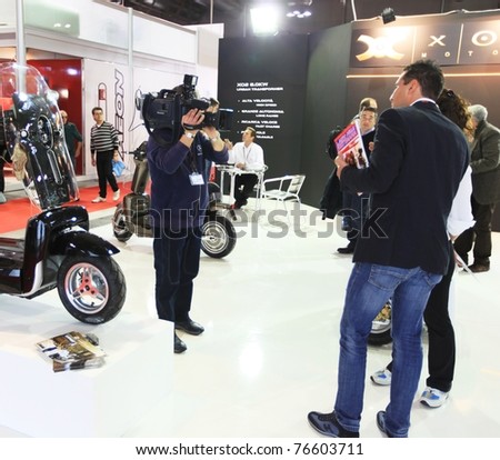 MILAN, ITALY - NOV. 03: People interview at EICMA, 68th International Motorcycle Exhibition November 03, 2010 in Milan, Italy.