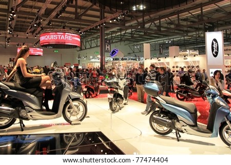 MILAN, ITALY - NOV. 03: People visit Honda motorcycles stand in exhibition at EICMA, 68th International Motorcycle Exhibition November 03, 2010 in Milan, Italy.