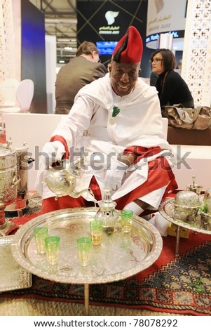 MILAN, ITALY - FEBRUARY 17: Man offering Tea at African stands during at BIT, International Tourism Exchange Exhibition on February 17, 2011 in Milan, Italy.