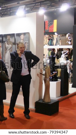 MILAN, ITALY - JANUARY 28: People on the phone at Macef, International Home Show Exhibition on January 28, 2011 in Milan, Italy.