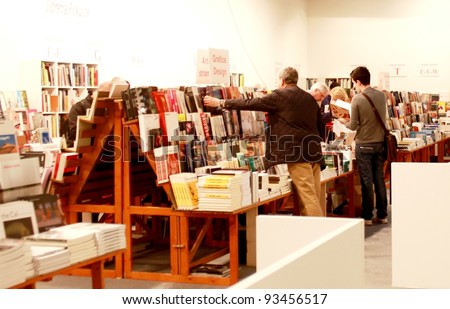 MILAN - MARCH 27: People look for arts books during MiArt ArtNow, international exhibition of modern and contemporary art March 27, 2010 in Milan, Italy.