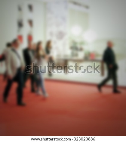 People at trade show, generic background. Intentionally blurred post production.