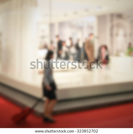 Trade show people, generic background. Intentionally blurred post production.