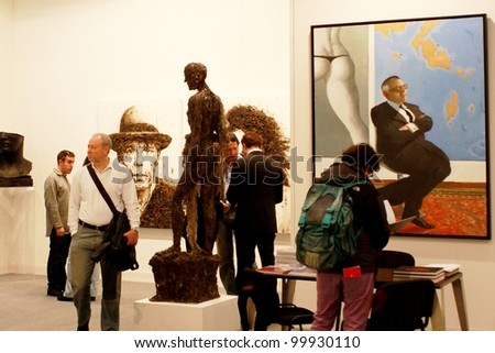 MILAN - MARCH 27: People look at paintings in exhibition at MiArt ArtNow, international exhibition of modern and contemporary art March 27, 2010 in Milan, Italy.