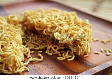 Instant noodles on wooden plate