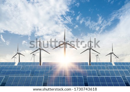 solar cell plant and wind generators under blue sky on sunset.Powerplant with photovoltaic panels and eolic turbine.clean energy and eco energy concept.