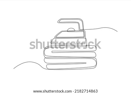 Continuous one line drawing iron on pile of clothes. Laundry service concept. Single line draw design vector graphic illustration.