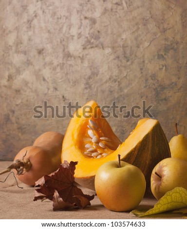 Still life with autumn vegetables and fruits on burlap background