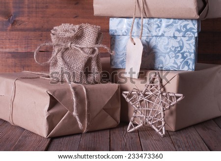 boxes with Christmas presents and santa hat on a wooden background