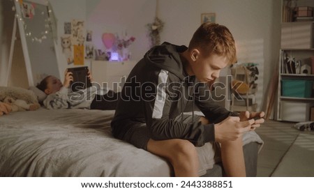 Similar – Image, Stock Photo Boy lying on a sofa using the laptop