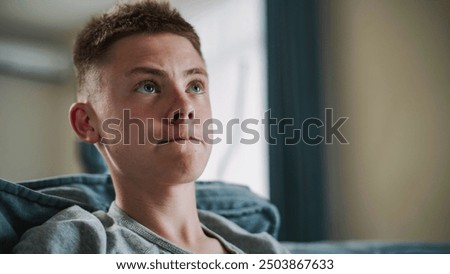 Similar – Image, Stock Photo Focused boy watching films on tablet
