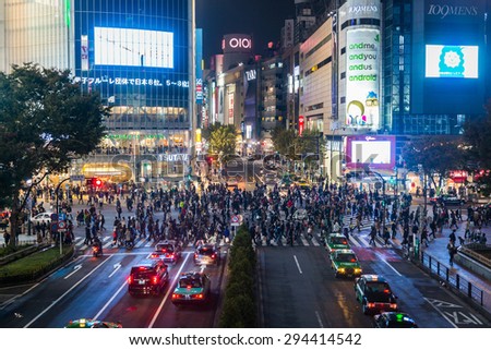 TOKYO, JAPAN - NOVEMBER 9: Pedestrians cross the Shibuya intersection on 9 November, 2014 in Tokyo, Japan. The Shibuya scramble crossing is the world\'s busiest pedestrian crossing.