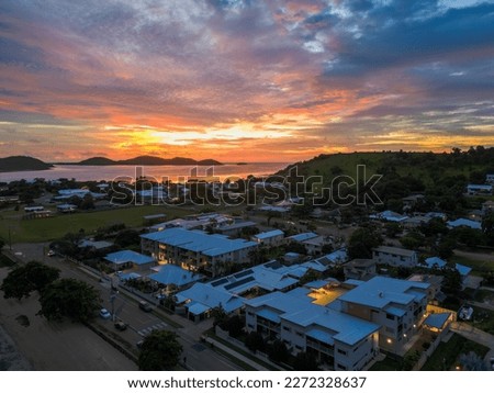 Similar – Image, Stock Photo Sunset on Thursday Island. In the golden glow, the water shines. In front a group of trees and behind a small island with passage to the sea.