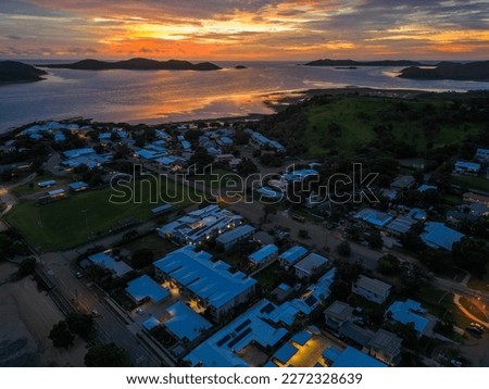 Similar – Image, Stock Photo Sunset on Thursday Island. In the golden glow, the water shines. In front a group of trees and behind a small island with passage to the sea.