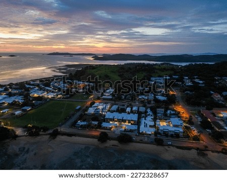 Similar – Image, Stock Photo Sunset on Thursday Island. In the golden glow, the water shines. In front a group of trees and behind a small island with passage to the sea.