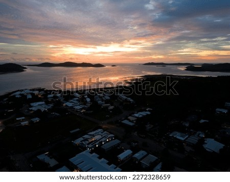 Similar – Image, Stock Photo Sunset on Thursday Island. In the golden glow, the water shines. In front a group of trees and behind a small island with passage to the sea.